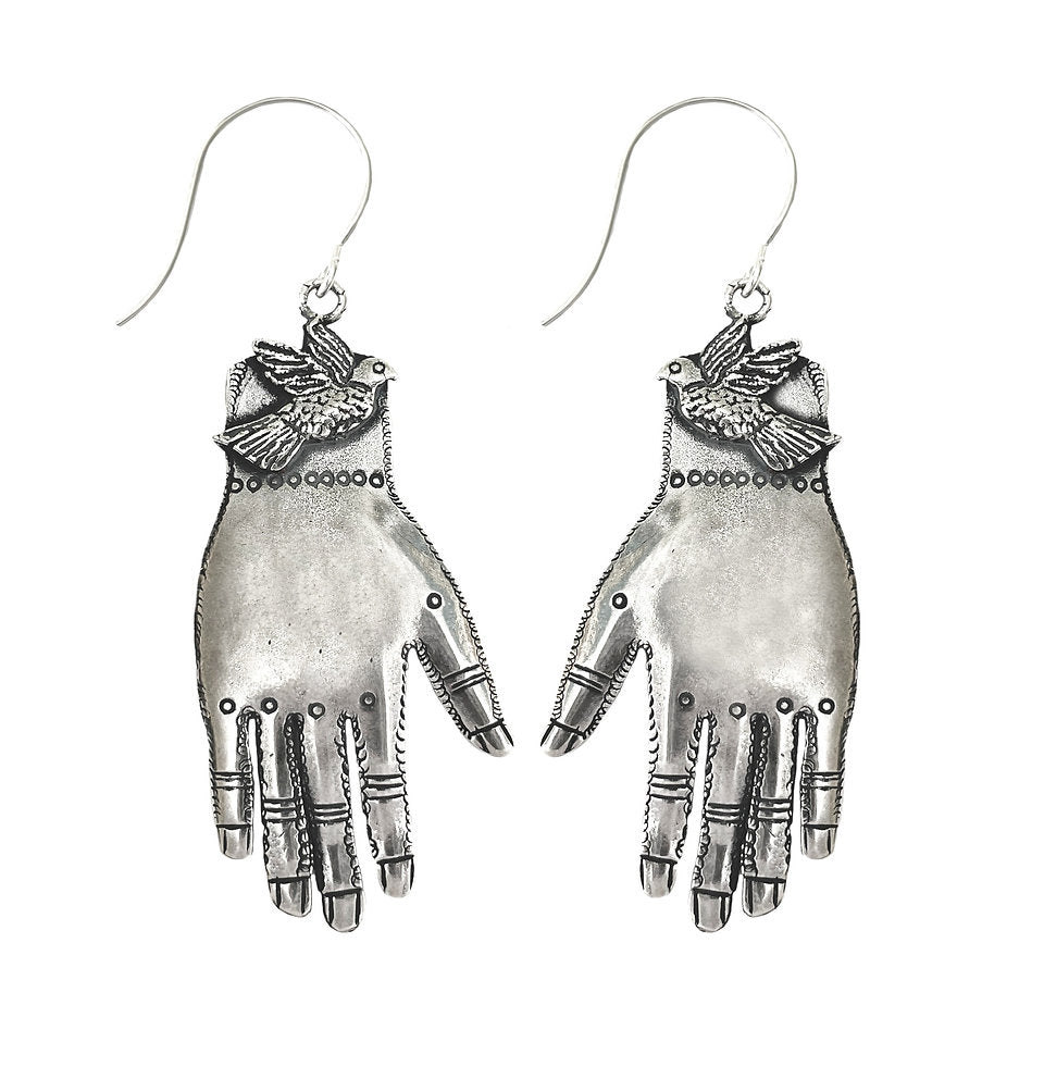 Silver hand-shaped earrings with a bird on a white background