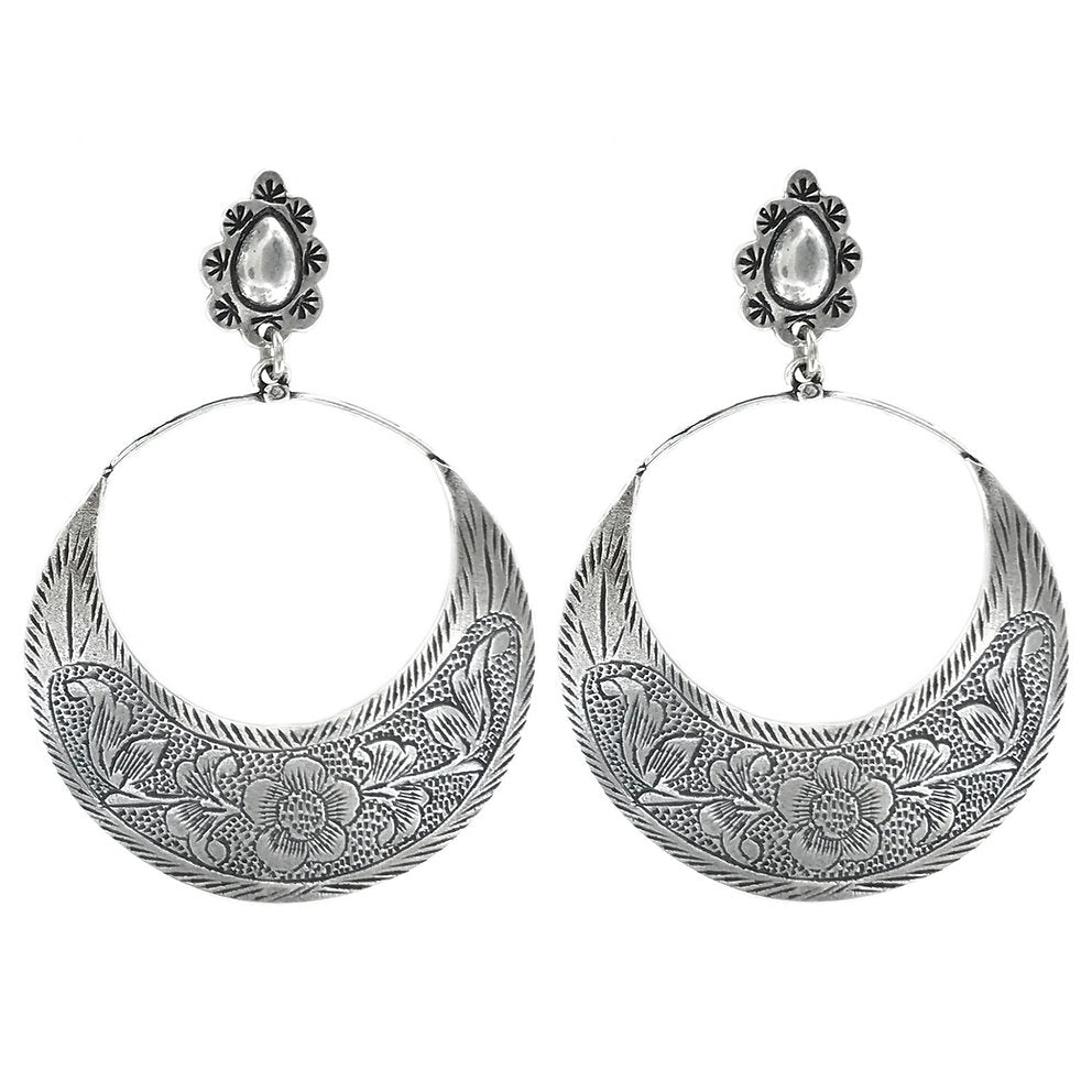 Pair of silver hoop earrings with intricate designs on a white background