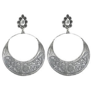 Pair of silver hoop earrings with intricate designs on a white background