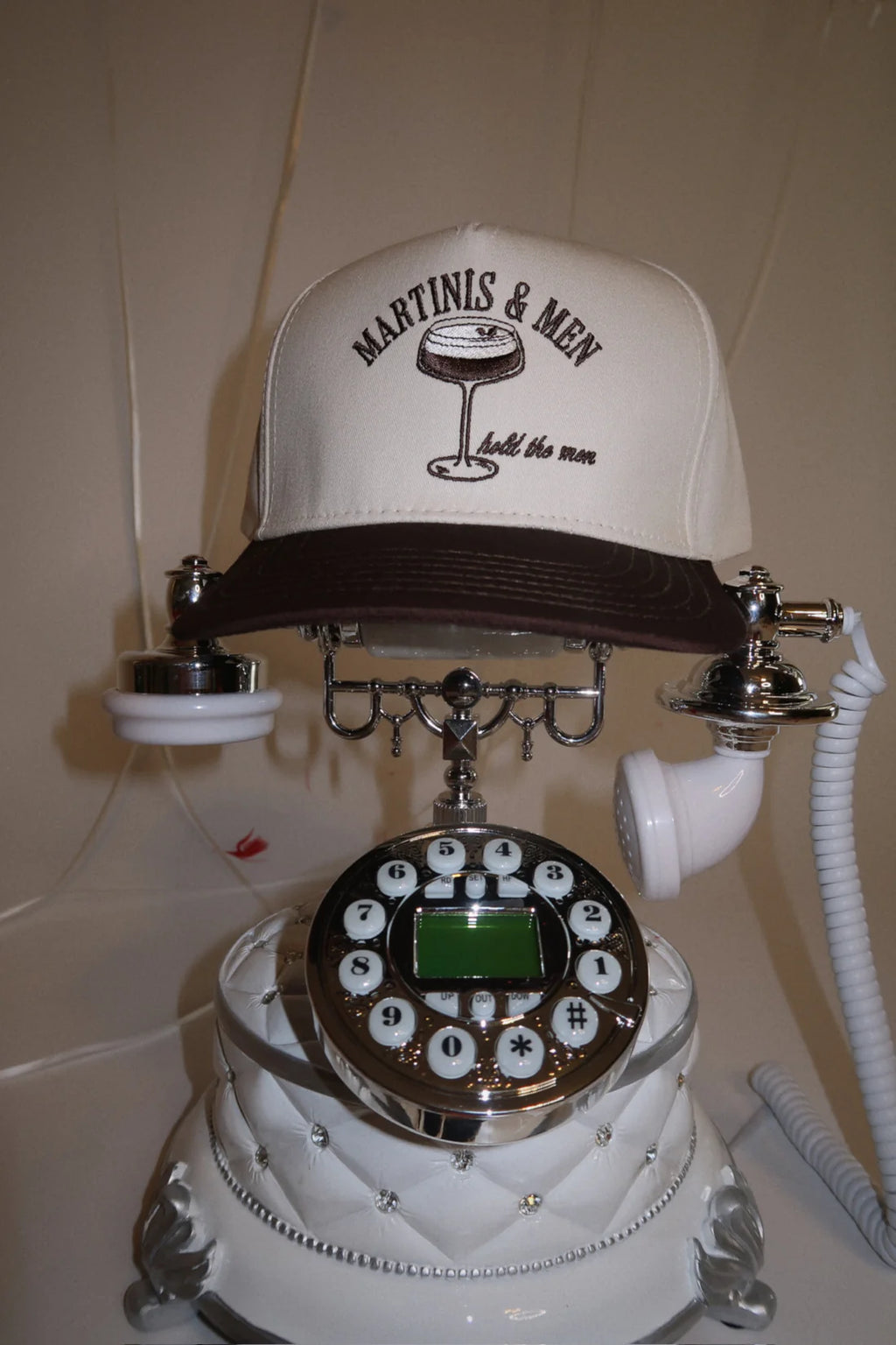 Vintage-style phone with a cap on top featuring 'Martinis & Men' text.