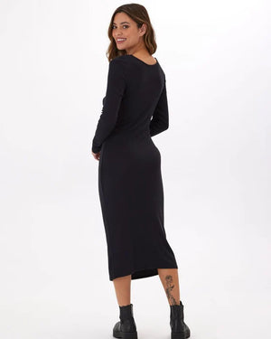 Twist and turn in style with the Threads 4 Thought Mira Dress. Made with feather rib fabric, this midi dress offers a playful and comfortable fit perfect for any occasion. Featuring a unique two-way twist and long sleeves, it's the perfect addition to your wardrobe for a fun and stylish look!