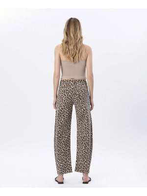 Woman wearing leopard print pants on a white background