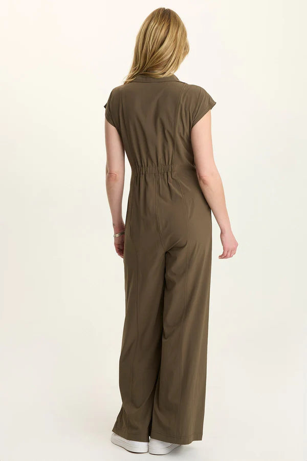 Person wearing a brown jumpsuit on a white background