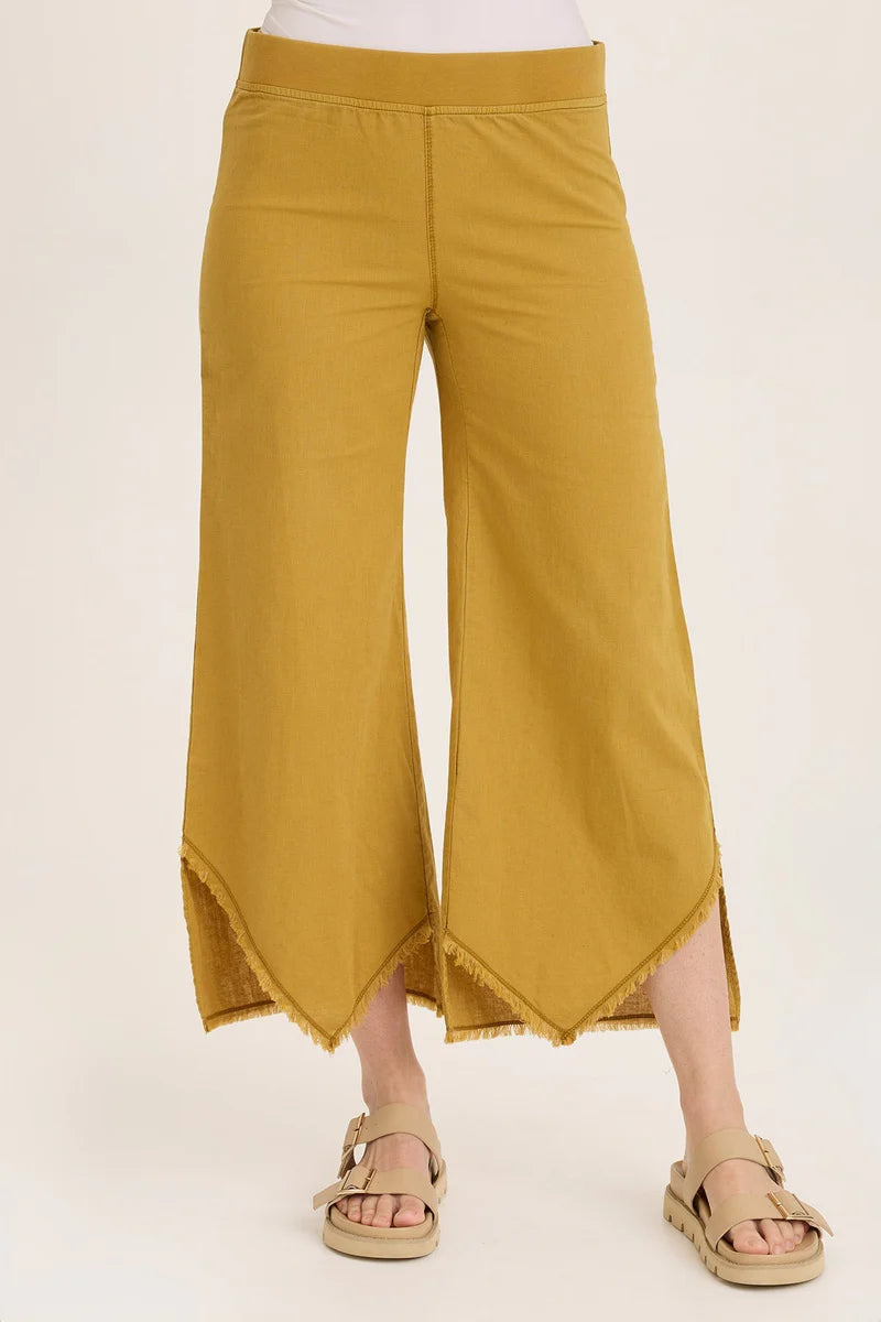 Mustard yellow wide-leg pants worn by a person on a white background