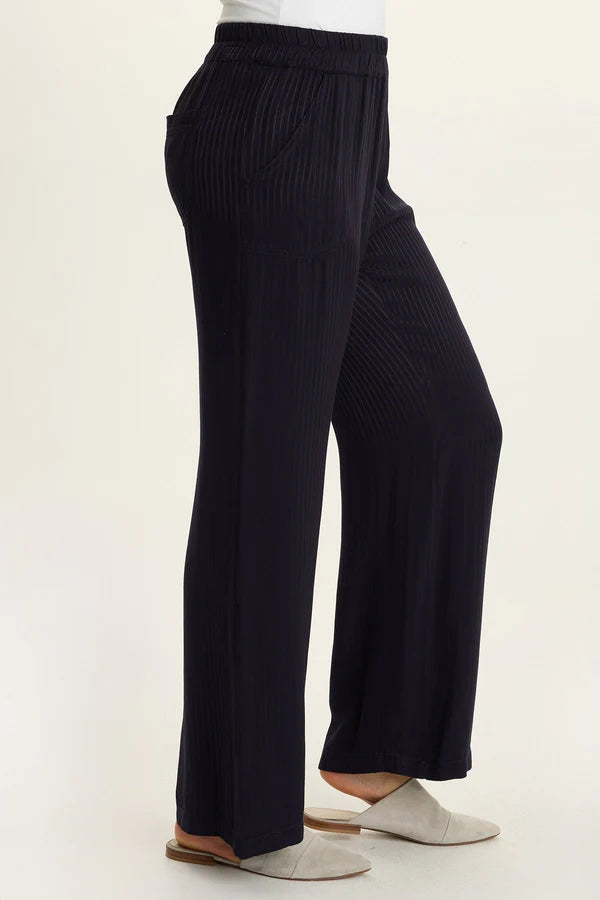 Black wide-leg pants worn by a person on a white background