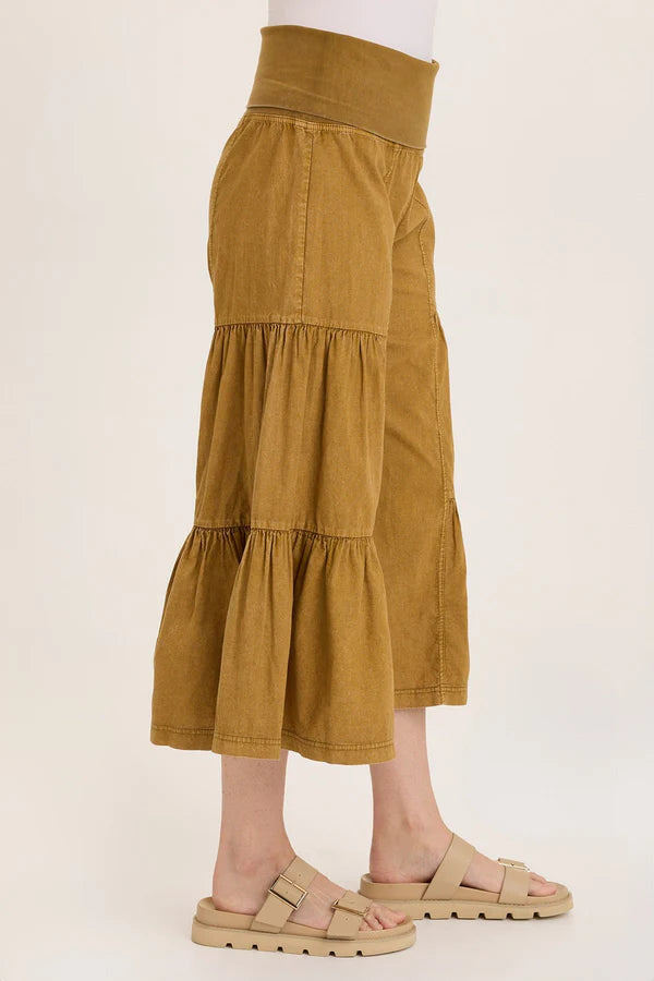 Brown tiered skirt worn by a person on a white background
