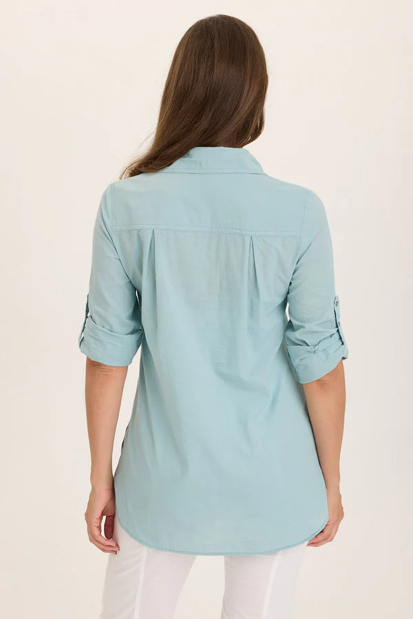 Light blue shirt worn by a person on a beige background