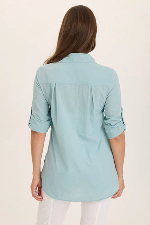 Light blue shirt worn by a person on a beige background