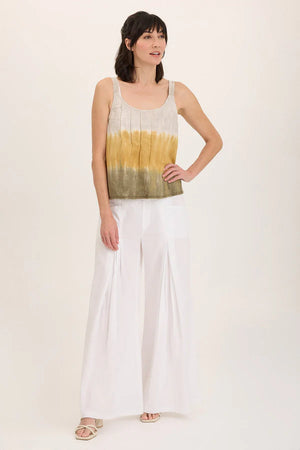 Woman wearing a sleeveless top with a gradient design and wide-leg pants on a white background