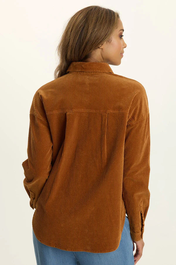 Woman wearing a brown corduroy shirt on a white background