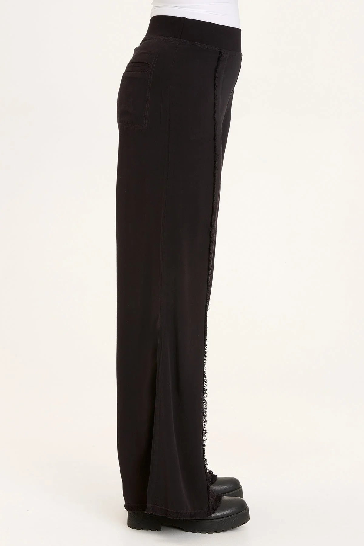 This wide leg trouser is now in our super soft Taissa. A pull-on elastic waistband and a faux fly, style lines with raw edges, back pockets, and raw edge hems.