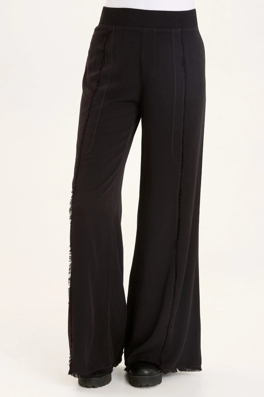 This wide leg trouser is now in our super soft Taissa. A pull-on elastic waistband and a faux fly, style lines with raw edges, back pockets, and raw edge hems.