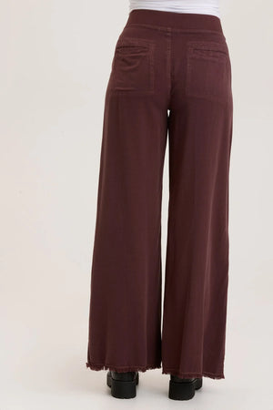 This wide leg trouser is now in our super soft Taissa. A pull-on elastic waistband and a faux fly, style lines with raw edges, back pockets, and raw edge hems.