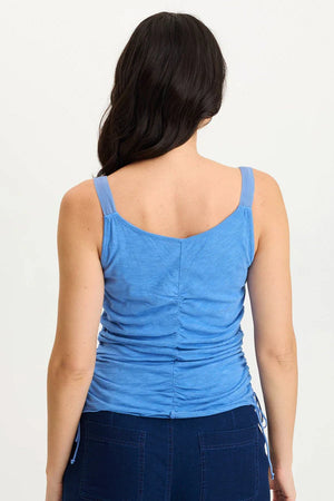 Woman wearing a blue tank top on a white background