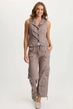 Woman wearing a brown sleeveless top and cargo pants on a white background