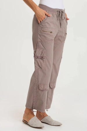 Beige cargo pants worn by a person on a white background