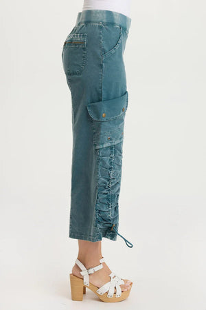 Teal cargo pants worn by a person on a white background