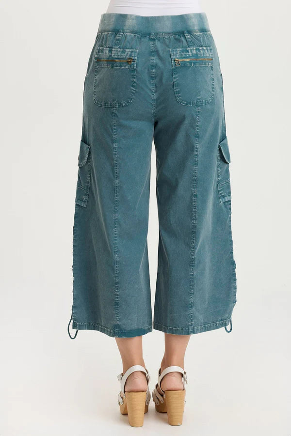 Teal cargo pants on a white background