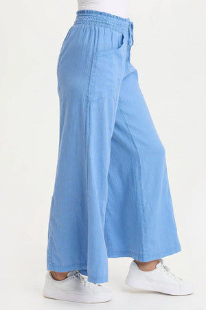 Light blue wide-leg pants worn by a person on a white background