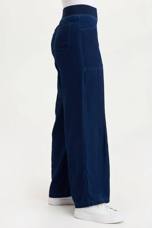 Navy blue wide-leg pants worn by a person on a white background