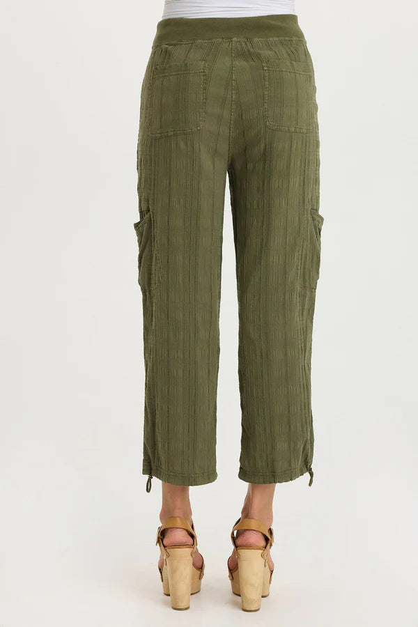 Green cargo pants worn by a person on a white background