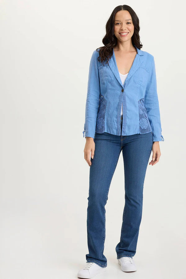 Woman wearing a blue jacket and jeans on a white background