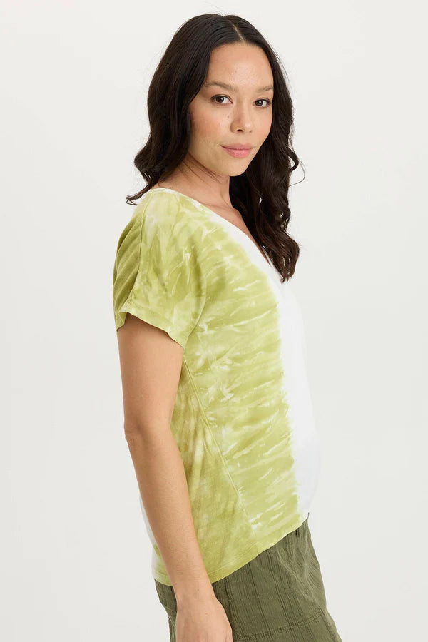 Woman wearing a green tie-dye shirt on a white background