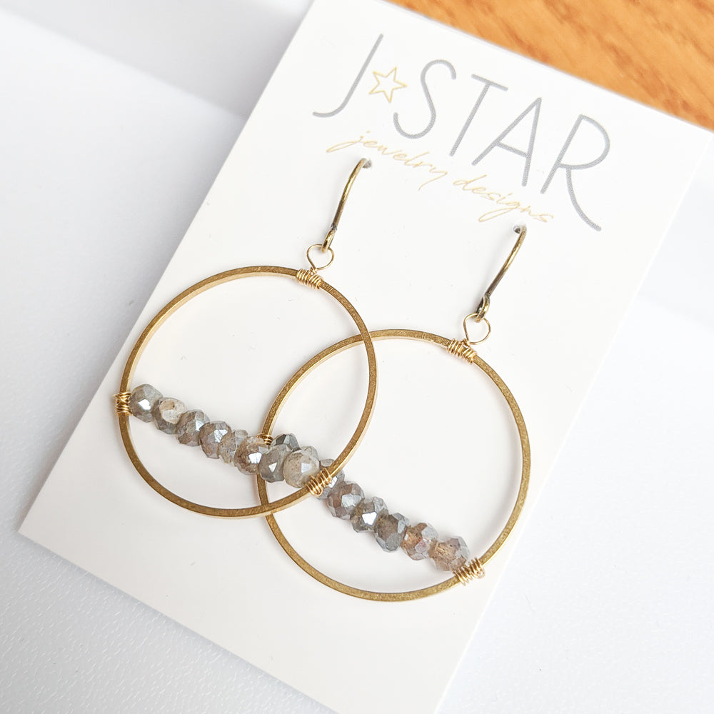 A simple strand of faceted labradorite stones accents brass wire circles.